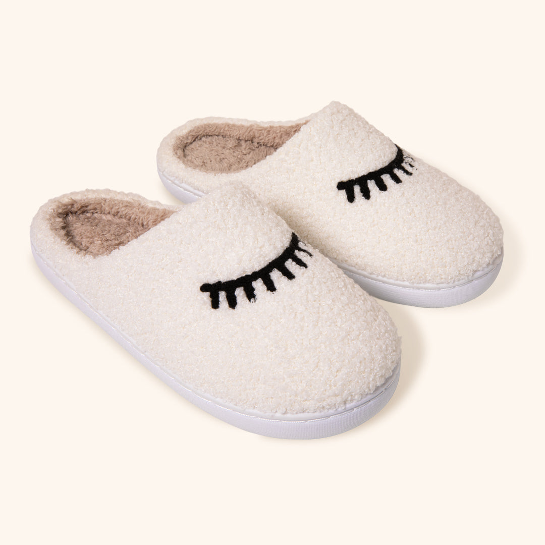 Pantufas de pelúcia aconchegantes com design de pestanas